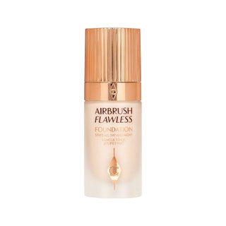 Charlotte Tilbury Airbrush Flawless Longwear Foundation cloudy transparent bottle of foundation with gold cap on white...